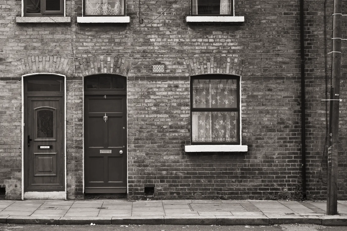 The front elevation of a brick terraced house on completion day, graded almost cold