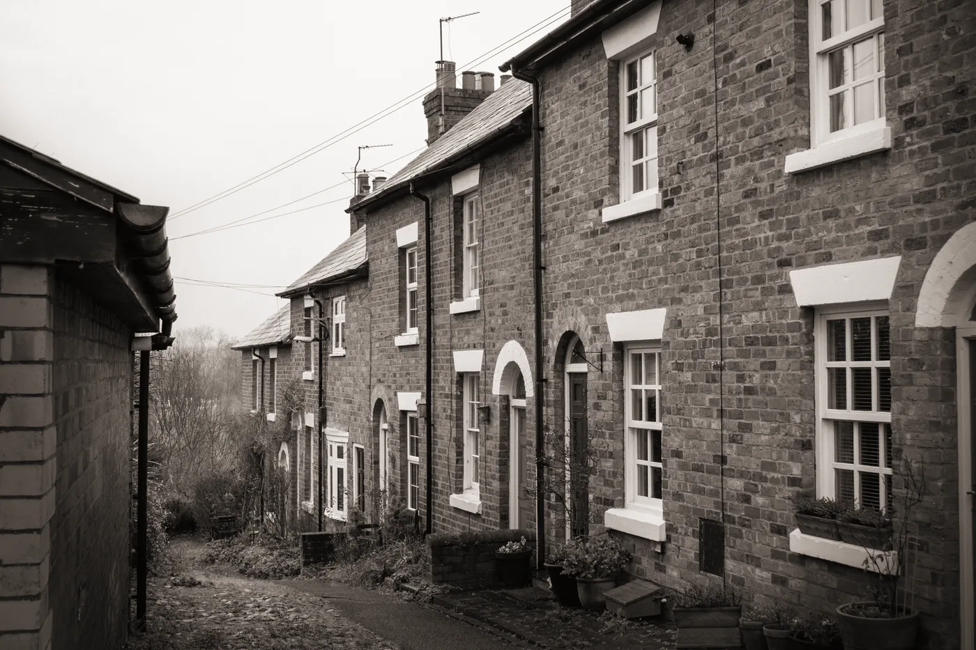 A terrace of brick houses on a quiet street, graded almost cold