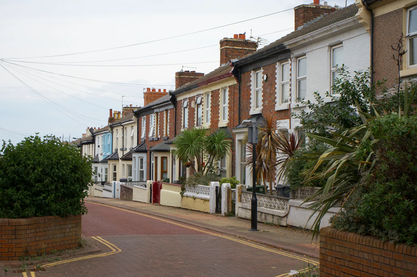 The same row of bay-fronted terraced houses, ungraded